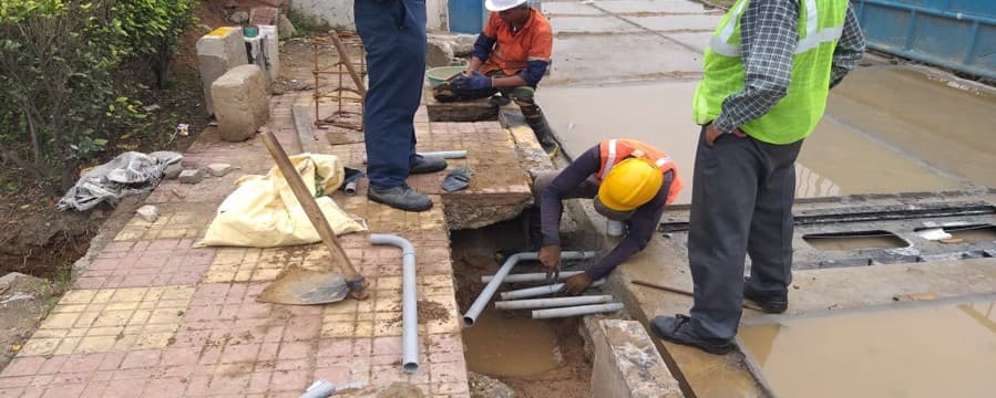 Installation crew laying cable conduit at an MS weigh in motion site